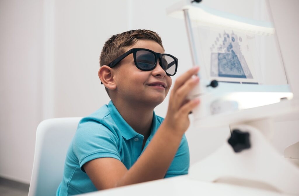 A young child performs a convergence test during his vision therapy session.