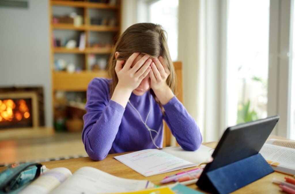 A child struggles to do homework because they're overwhelmed by the amount of near-work they'll have to do.