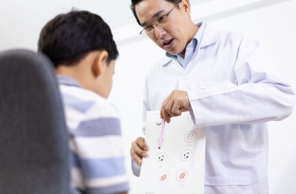 A vision therapist assesses a child's depth perception during their initial consultation.